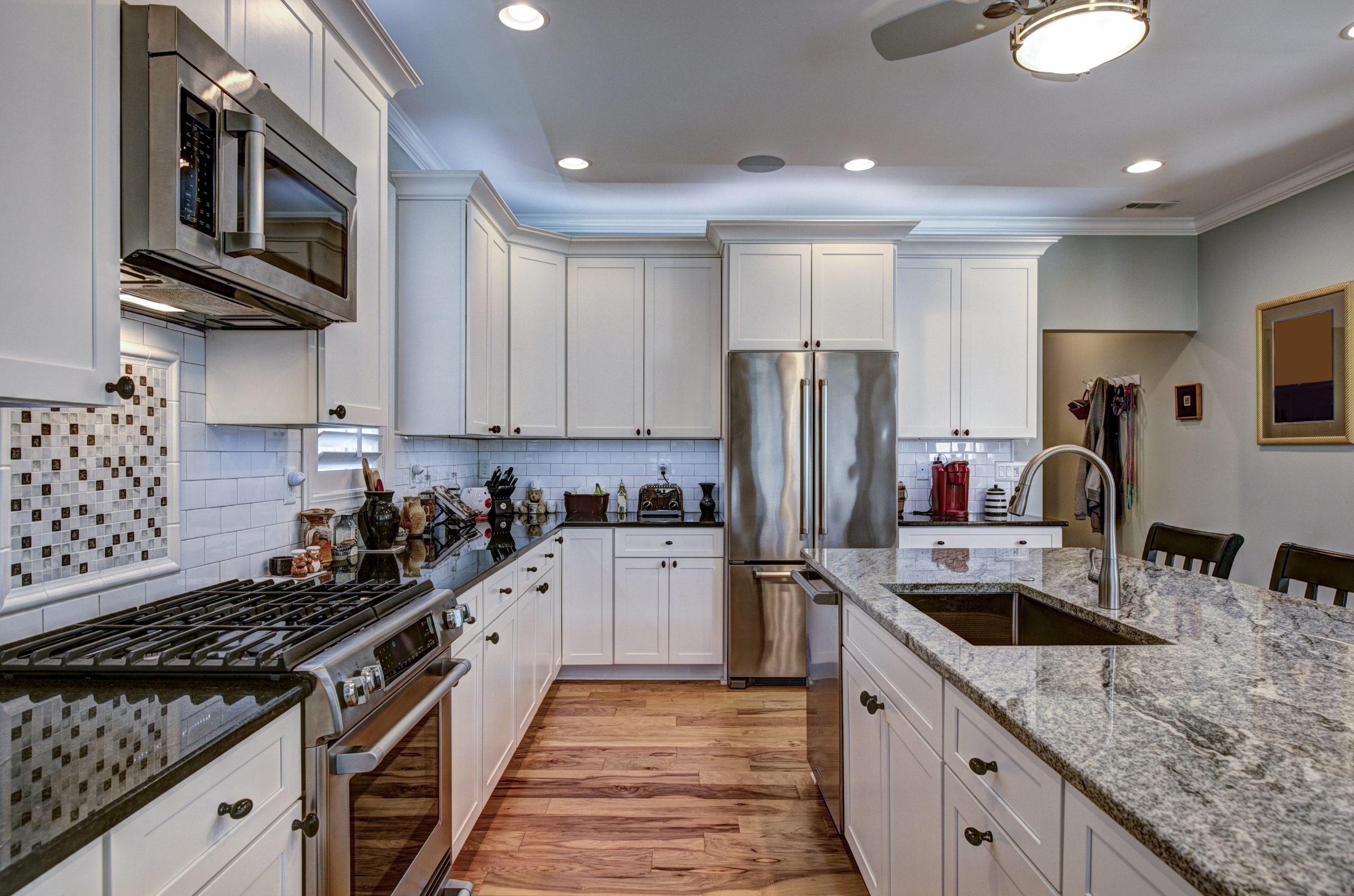 Clean kitchen with sparkling countertops and stainless steel appliances